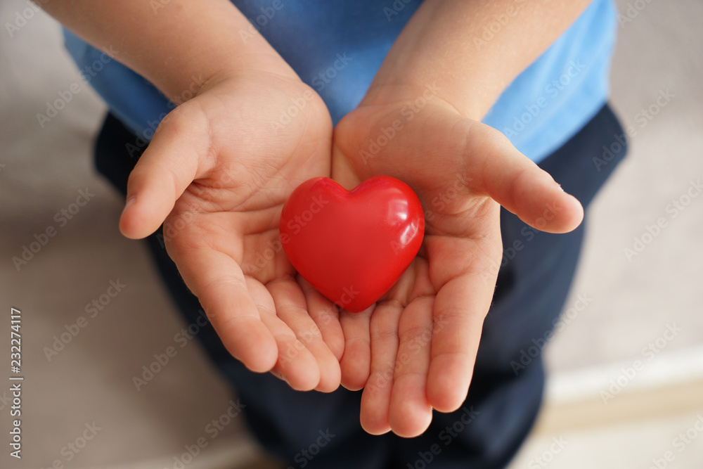 Little boy holding decorative heart, closeup Little boy holding decorative heart, closeup