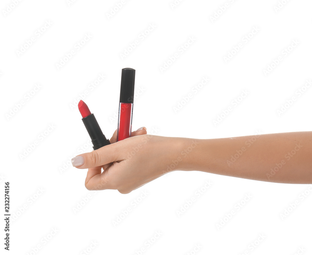 Woman holding lip gloss and lipstick on white background Woman holding lip gloss and lipstick on white background