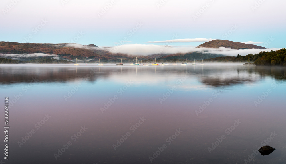 Fototapeta premium A misty dawn over Loch Lomond from Milarrochy Bay
