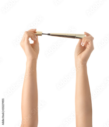 Woman holding lash mascara on white background