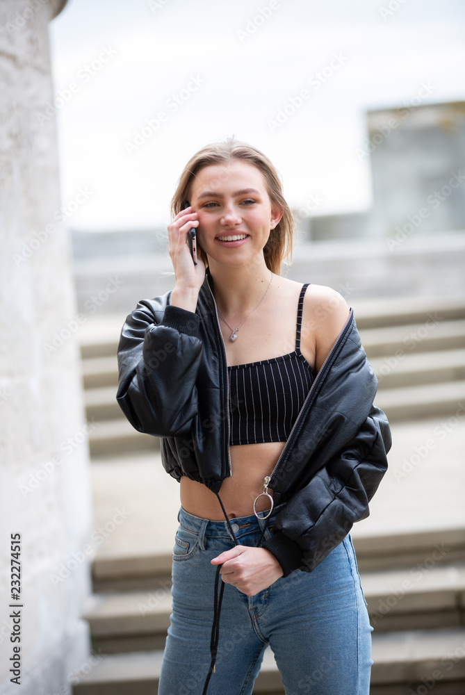 Teenage girl talking on mobile phone happy