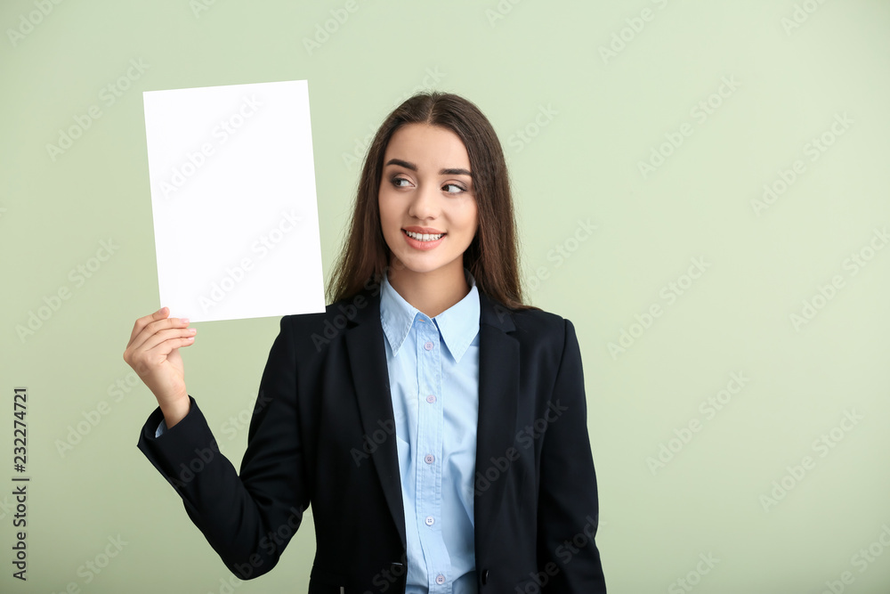 Young woman with blank sheet of paper on light background Young woman with blank sheet of paper on light background
