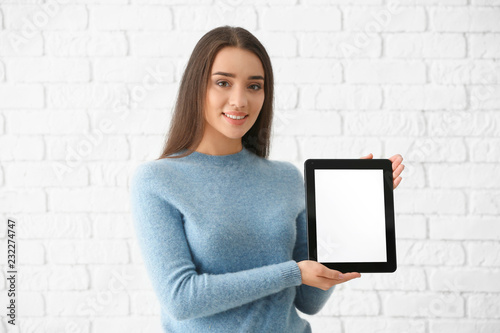 Young woman with tablet com...