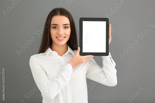 Young woman holding tablet ...