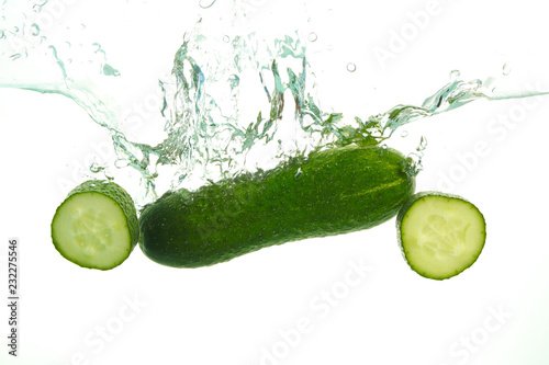 Green Cucumber in water splash on white photo