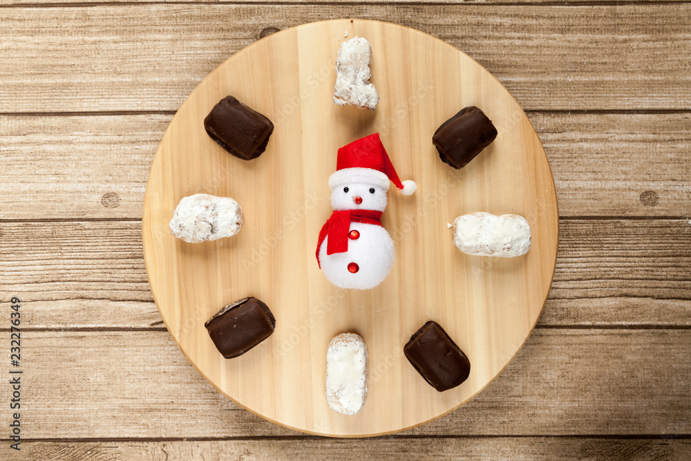 typical Spanish almond and almond and chocolate polvoron  with Santa clock