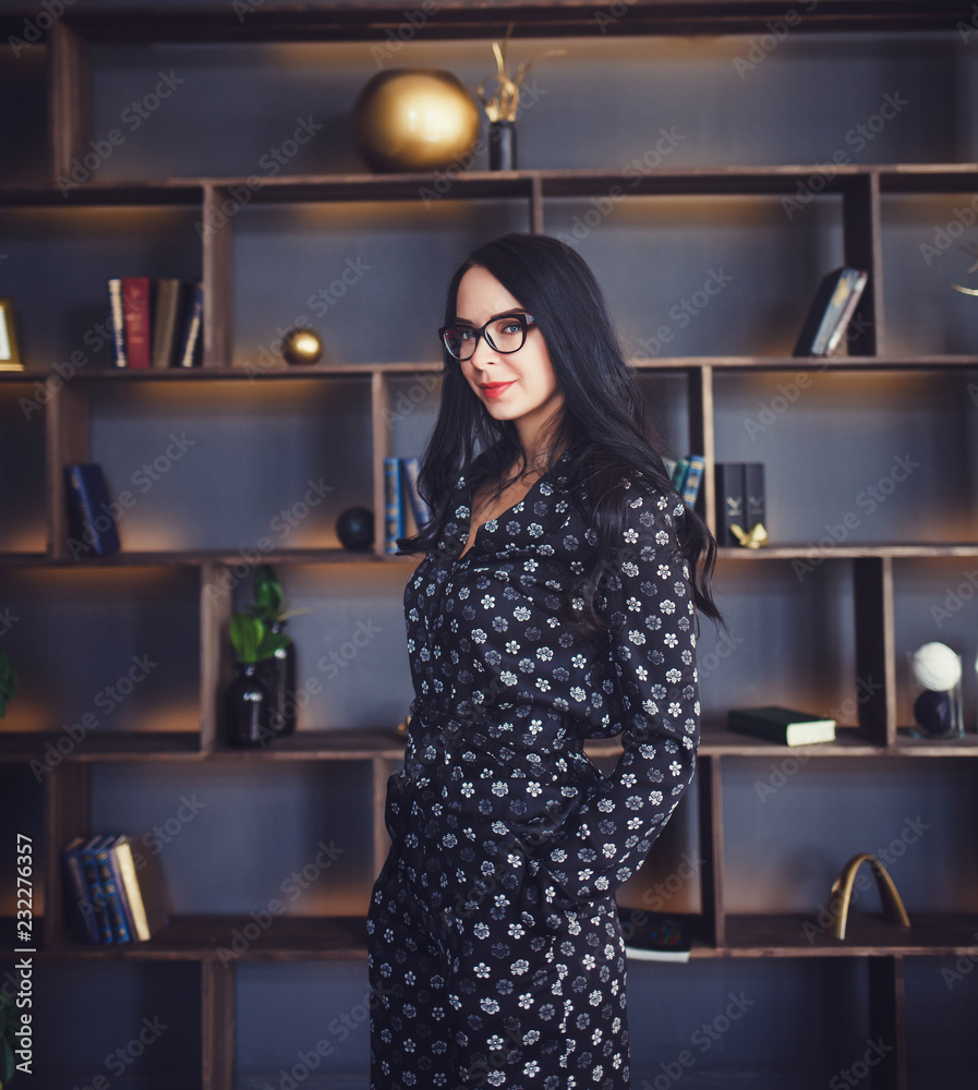beautiful and successful woman with a smile standing in the office