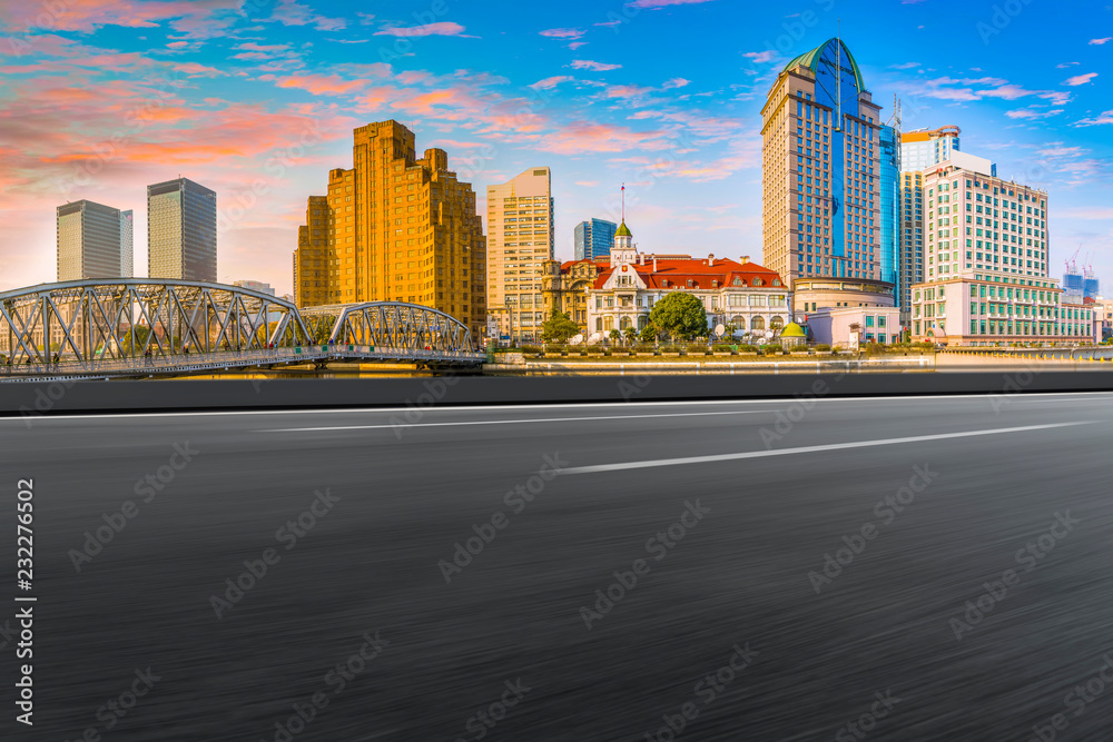 Fototapeta premium Empty asphalt road along modern commercial buildings in China's cities