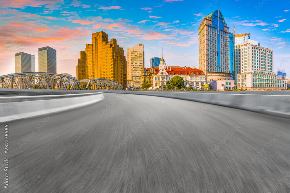 Empty asphalt road along modern commercial buildings in China's cities