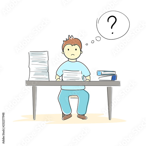 Boy sitting behind his table with a lot of papers
