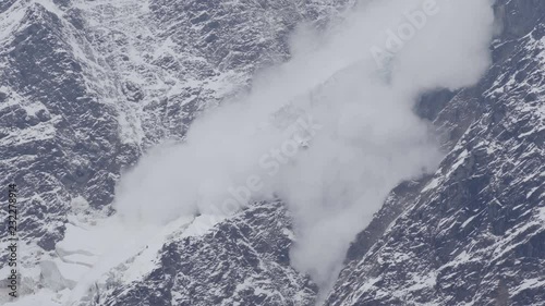 Avalanche is coming down a glacier in the Caucasus Mountains, Russia photo