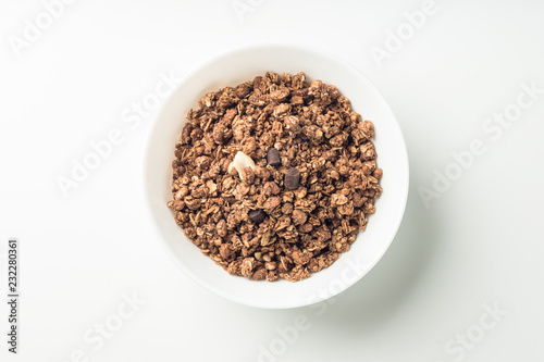 Granola breakfast on a bowl over white background