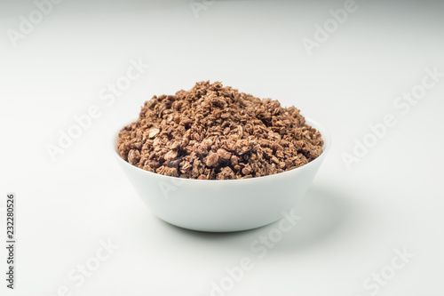 Granola breakfast on a bowl over white background © Sloniki