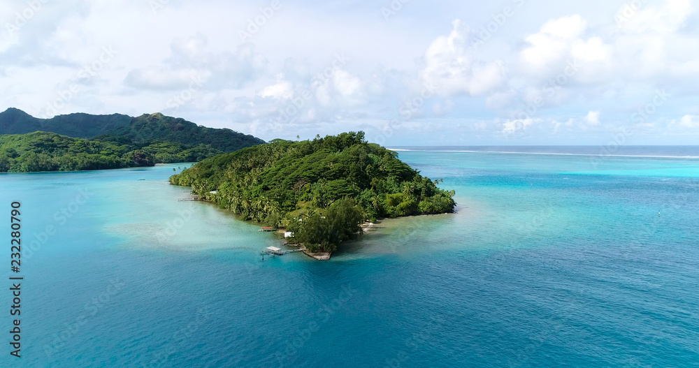 Summer island in the Pacific with lagoon. Perfect view for travel and tourism in French Polynesia - aerial view with a drone - Vacation and tourism concept Summer island in the Pacific with lagoon. Perfect view for travel and tourism in French Polynesia - aerial view with a drone - Vacation and tourism concept