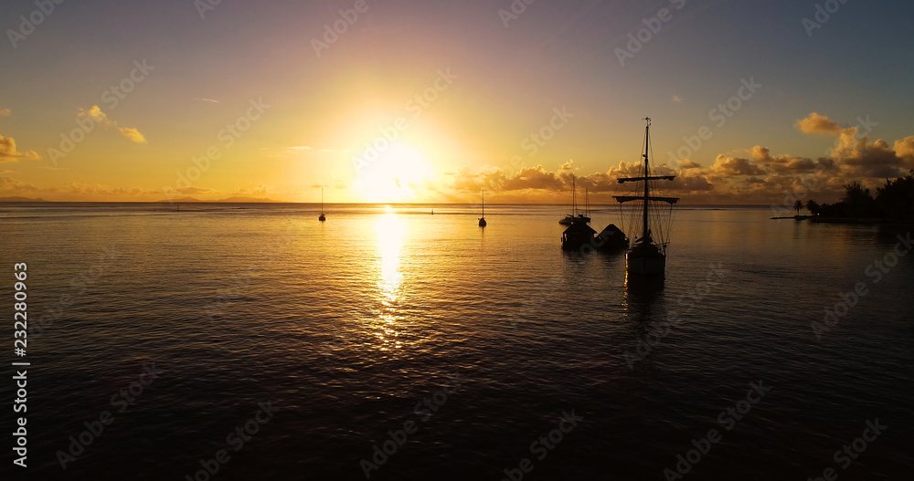 boat with Sunset in aerial view , french polynesia