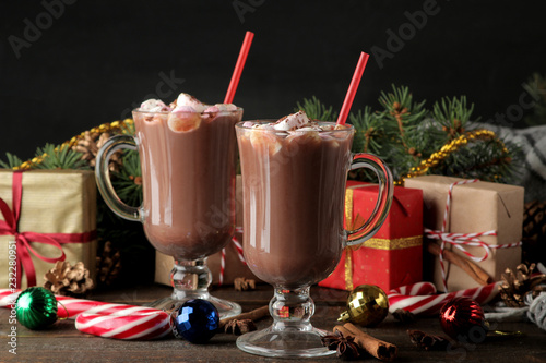 hot cocoa with marshmallows in a glass cup on a brown wooden background. Winter. new Year. Christmas. tree gifts