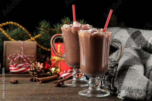 hot cocoa with marshmallows in a glass cup on a brown wooden background. Winter. new Year. Christmas. tree gifts