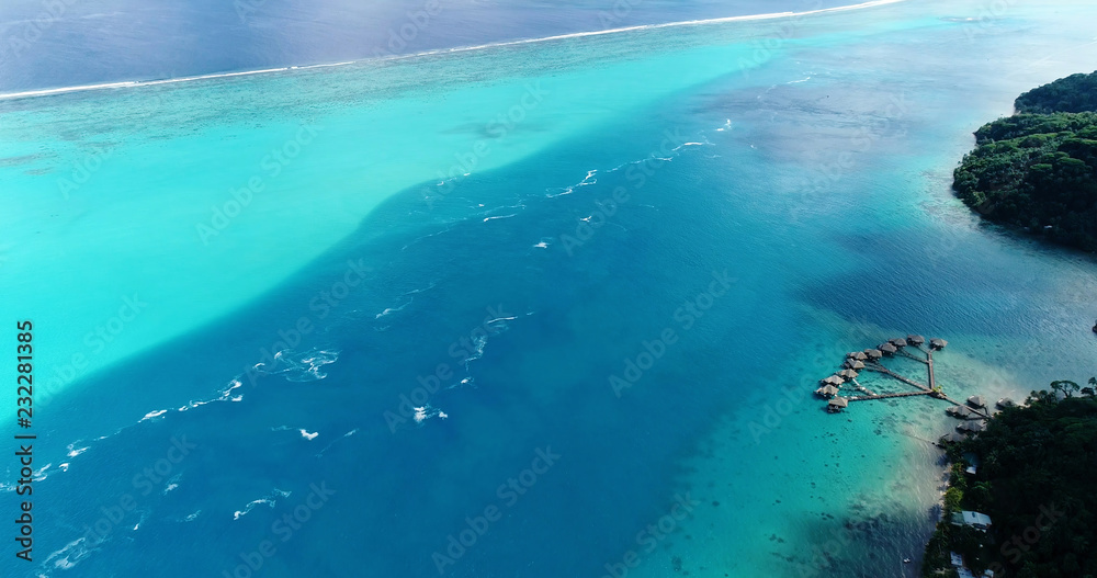 bungalow on the water in aerial view, french polynesia