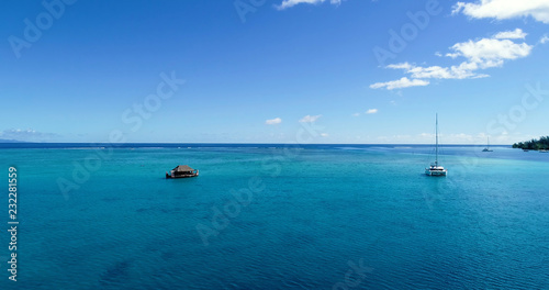 boat bungalow (house) on a lagoon in aerial view, French Polynesia