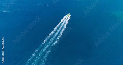 boat in a lagoon in French Polynesia, in aerial view © Fly_and_Dive