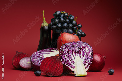 Photography close-up view of sliced cabbage, beetroot, onions, eggplants, apple and grapes o