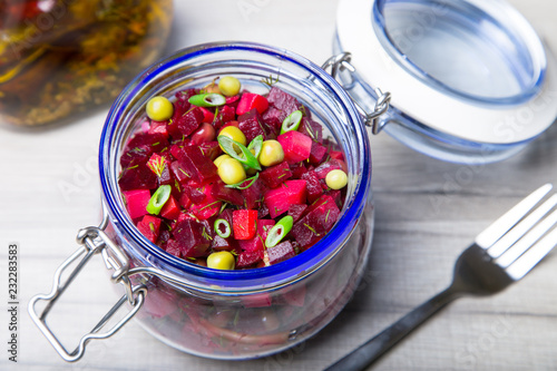 Vinaigrette salad with olive (vegetable) oil in a jar. Selective focus, close-up.