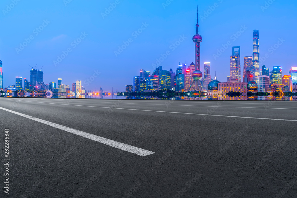 Empty asphalt road along modern commercial buildings in China's cities