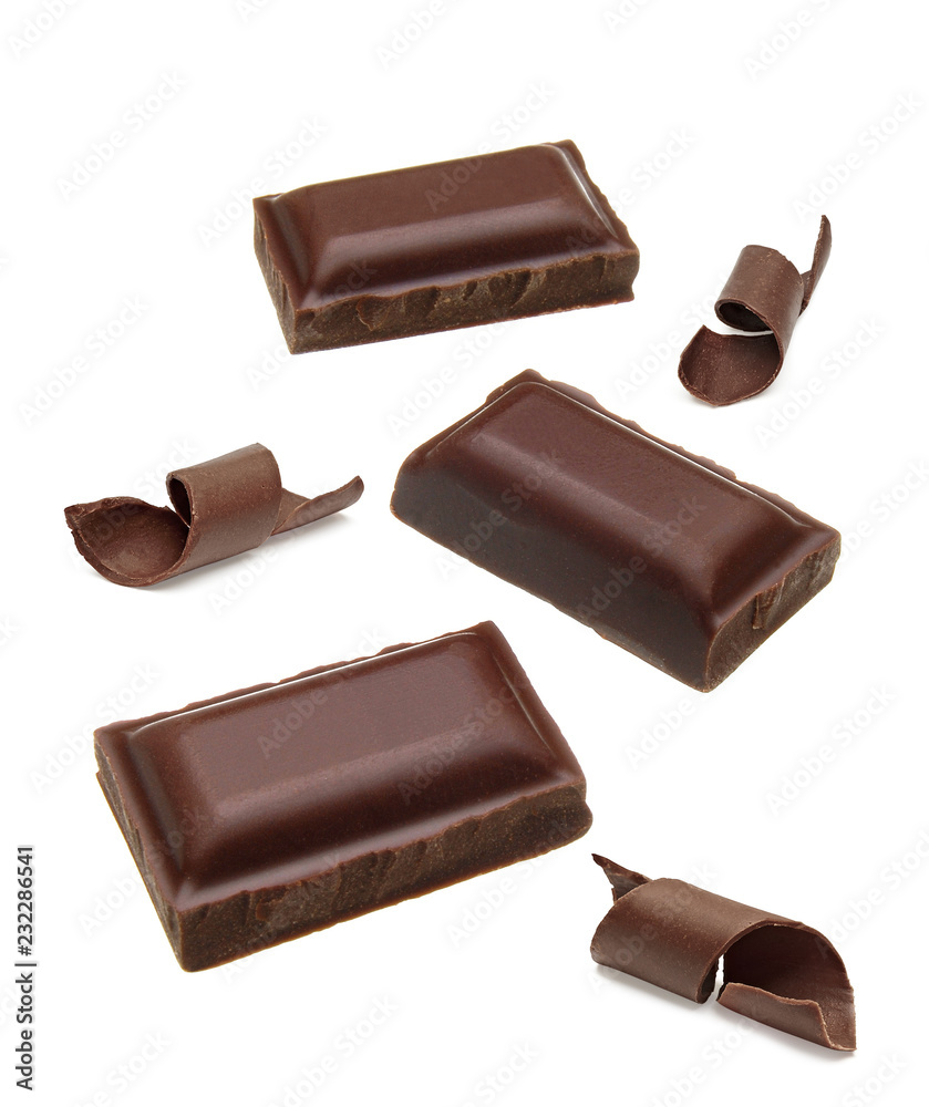 Broken dark chocolate bars and curls isolated on white background pieces Broken dark chocolate bars and curls isolated on white background pieces