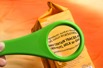 Empty magnifying glass on food additives label with copy space for your text. Concept reading ingredients and additives list. 