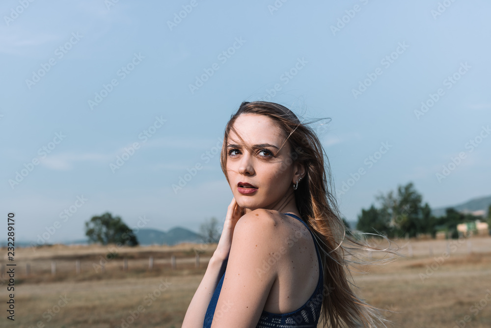 Elegant woman standing in field Elegant woman standing in field