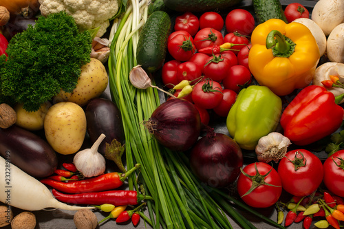 Vegetables and nuts on a brown wooden background