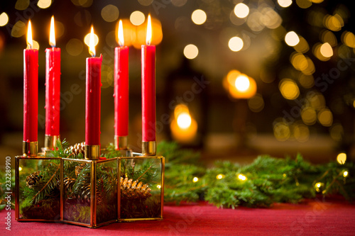 Photography Background of glass and gold candleholder with red candles and spruce branches on red table cloth