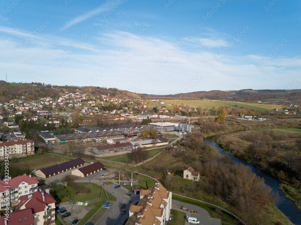 Strzyzow, Poland - 9 9 2018: View of the factory and residential area for workers with low multi-storey houses. Panorama from the drone or quadrocopter with a bird's-eye view. Architectural layout of 