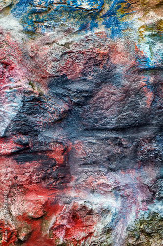 Old abstract red blue multi coloured painted brick wall background 
