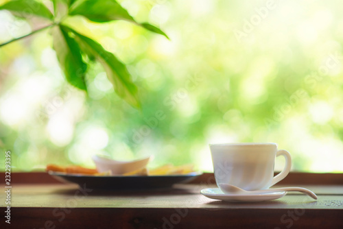 white coffee cup on wood table and bokhe back ground