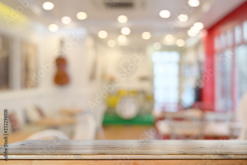 Empty wooden table counter and cafe background