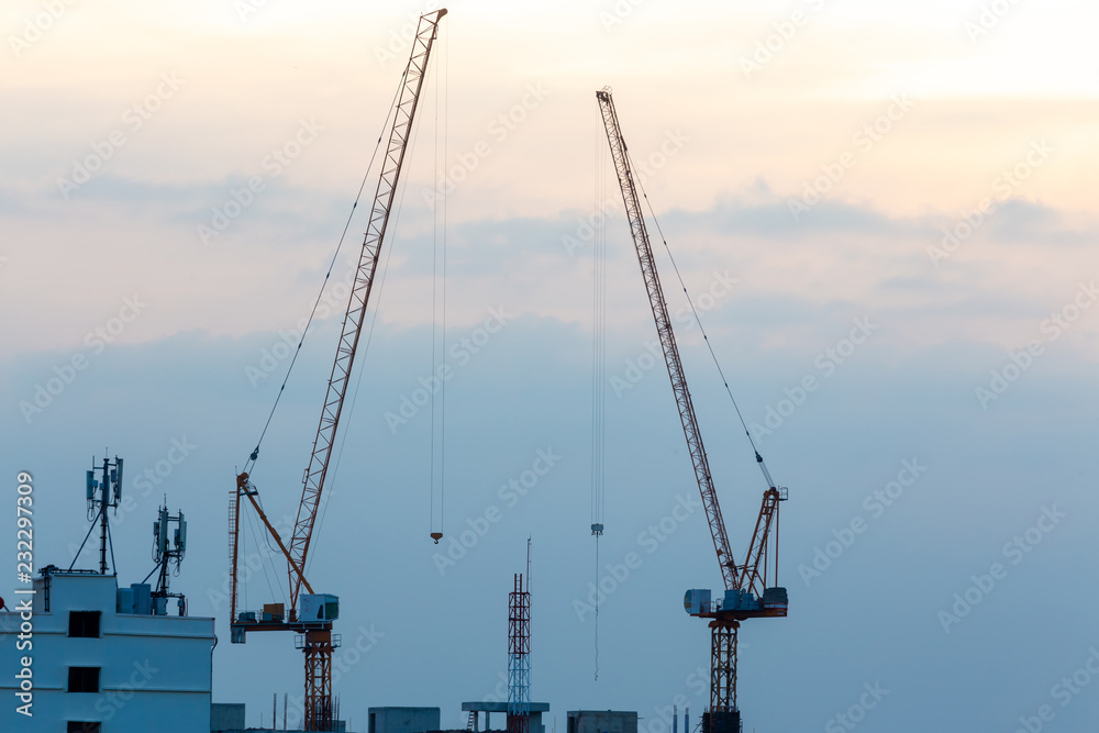 Fototapeta premium Construction crane Dramatic sunset ,colorful of sky with cloudsConstruction crane
