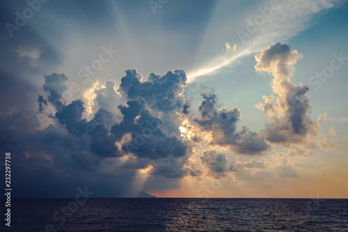 Wallpaper Mural Sun rays and dark clouds on sky at the sea before sunset in the evening Torontodigital.ca