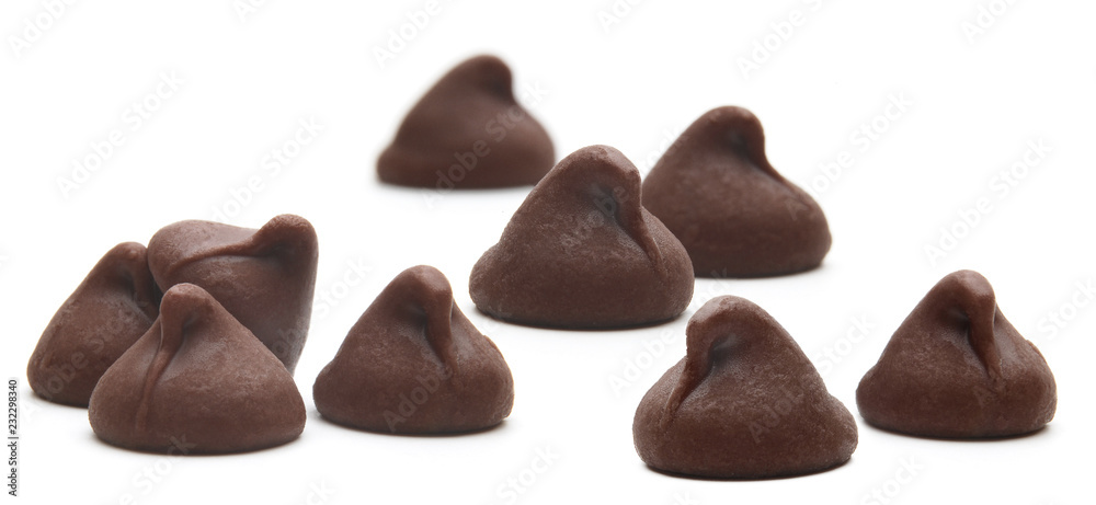 Fototapeta premium Scattered chocolate chips morsels pile from top view isolated on white background