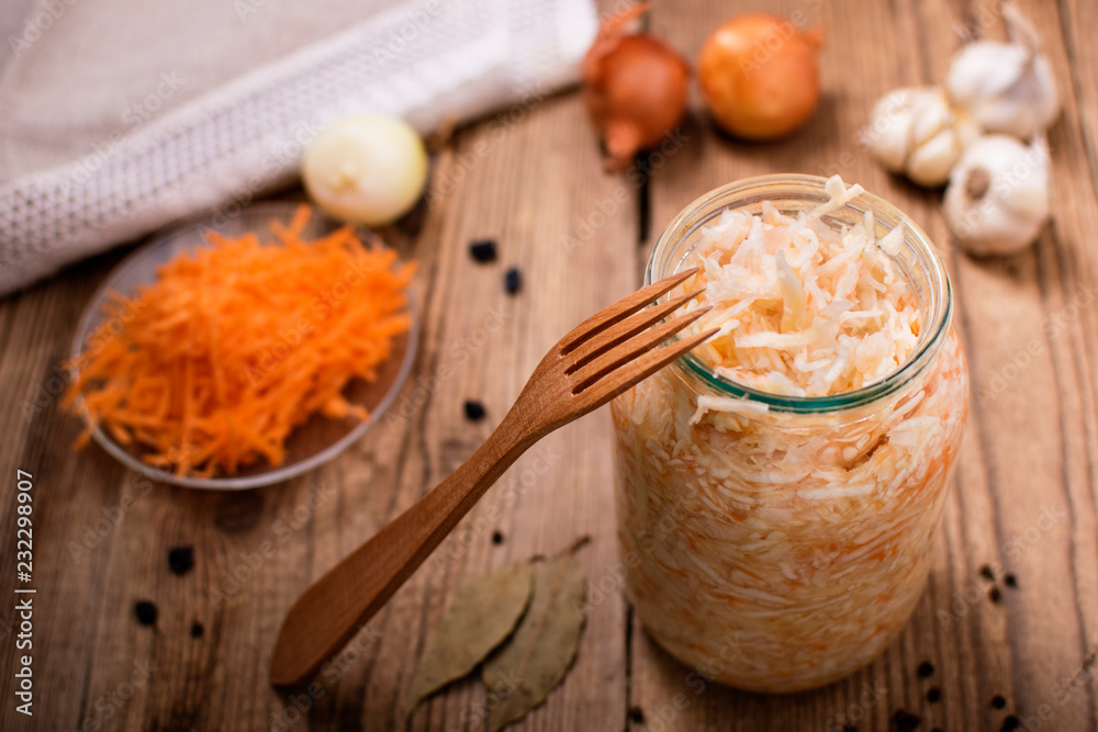 sauerkraut in a jar, on a wooden table, ingredients