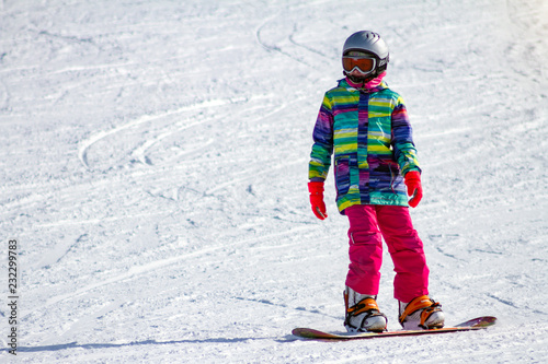 Girl snowboarder on ski track. Free space for text