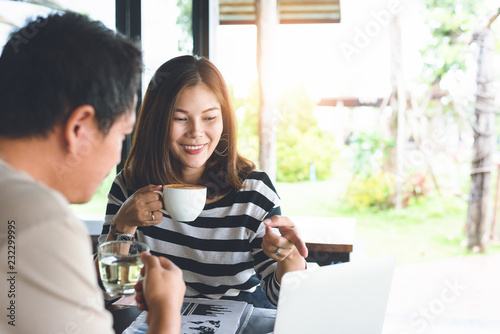 asians conversation friend concept.Women are raising their favorite coffee with a smile, Men and women are discussing about their work.