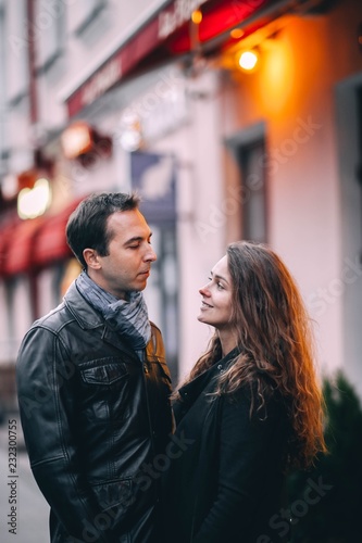 loving couple walks around the Christmas city in winter clothes. Romantic walk on holidays.