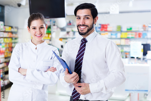 Two pharmacists standing in drugstore