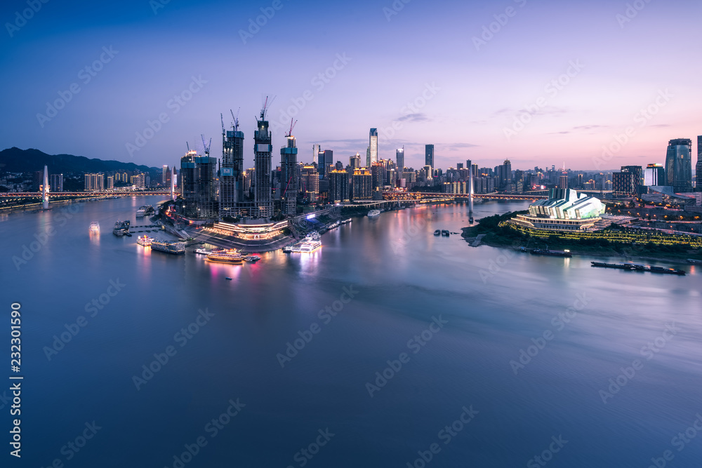 cityscape and skyline of downtown near water of chongqing at night