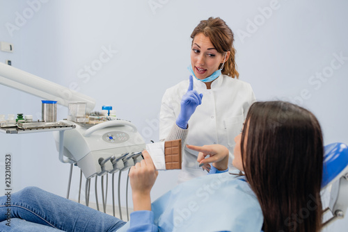 Dentist Won t Let a Girl Eating Chocolate. Health food concept
