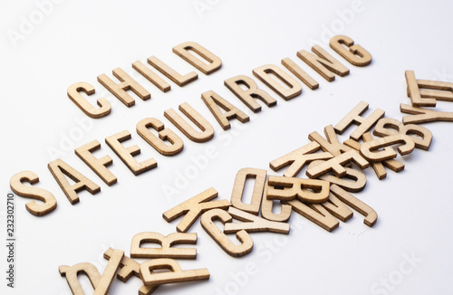 Child safeguarding concept, word spelled out in wooden letters photo