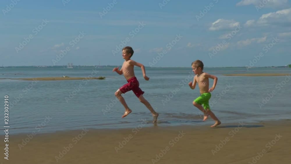 happy kids running at beach. Summer vacation boys. happy kids running at beach. Summer vacation boys.