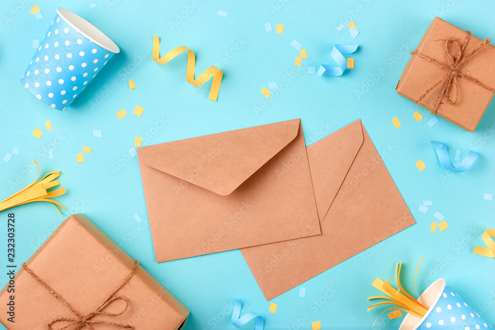 Celebration envelope, birthday party things and laptop on a yellow background Celebration envelope, birthday party things and laptop on a yellow background