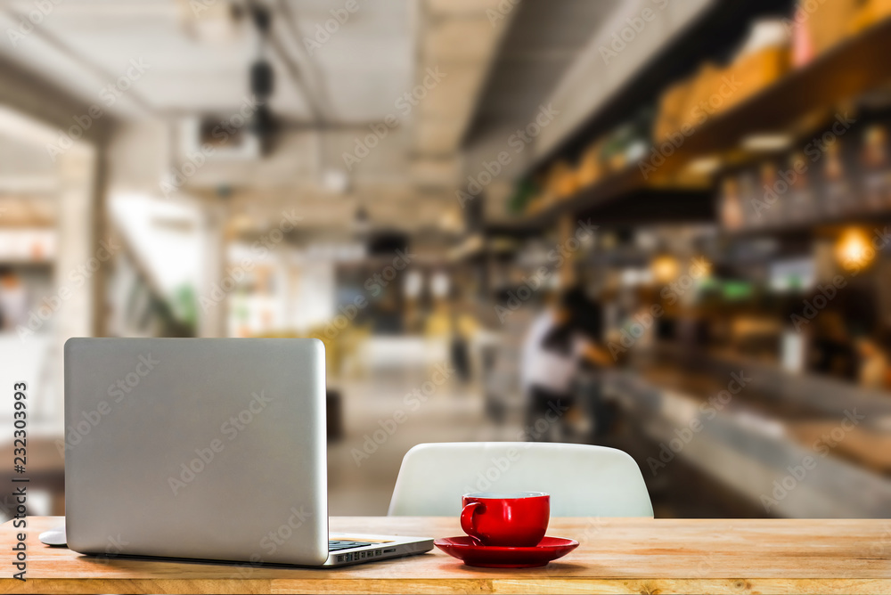 Workplace with notebook laptop and coffee cup Comfortable work table in cafe. Workplace with notebook laptop and coffee cup Comfortable work table in cafe.